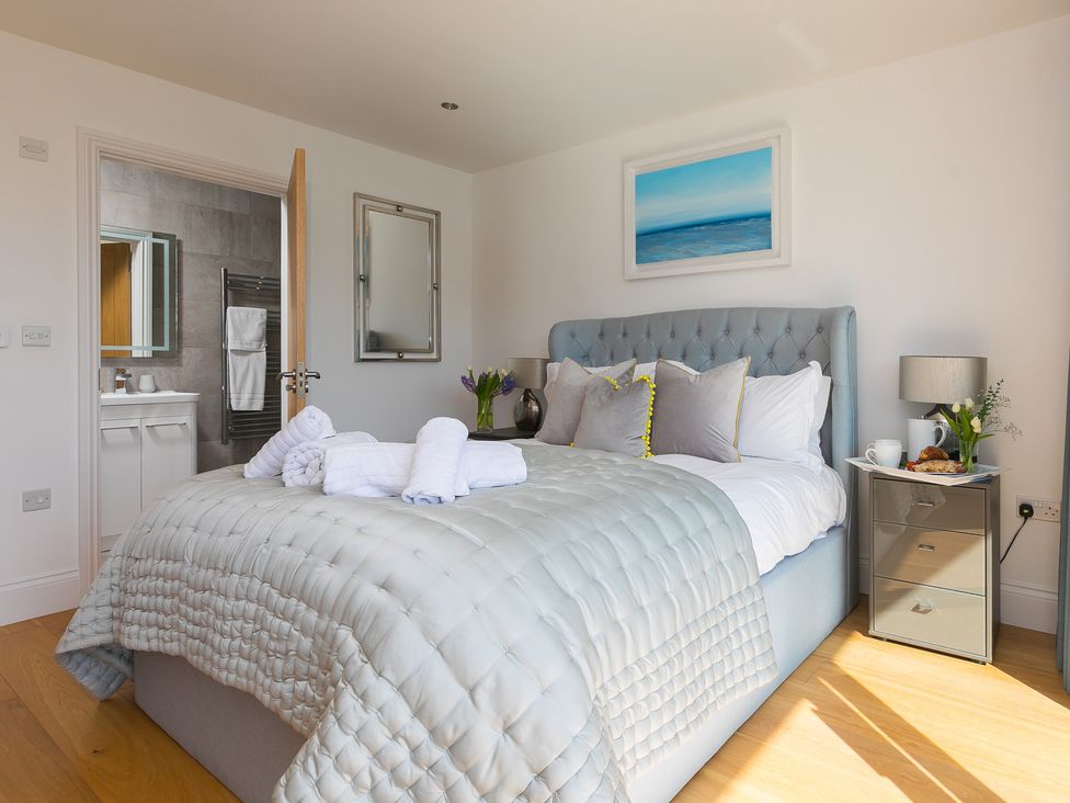 A bedroom with a bed and adjacent bathroom at 2 Remera St Ives
