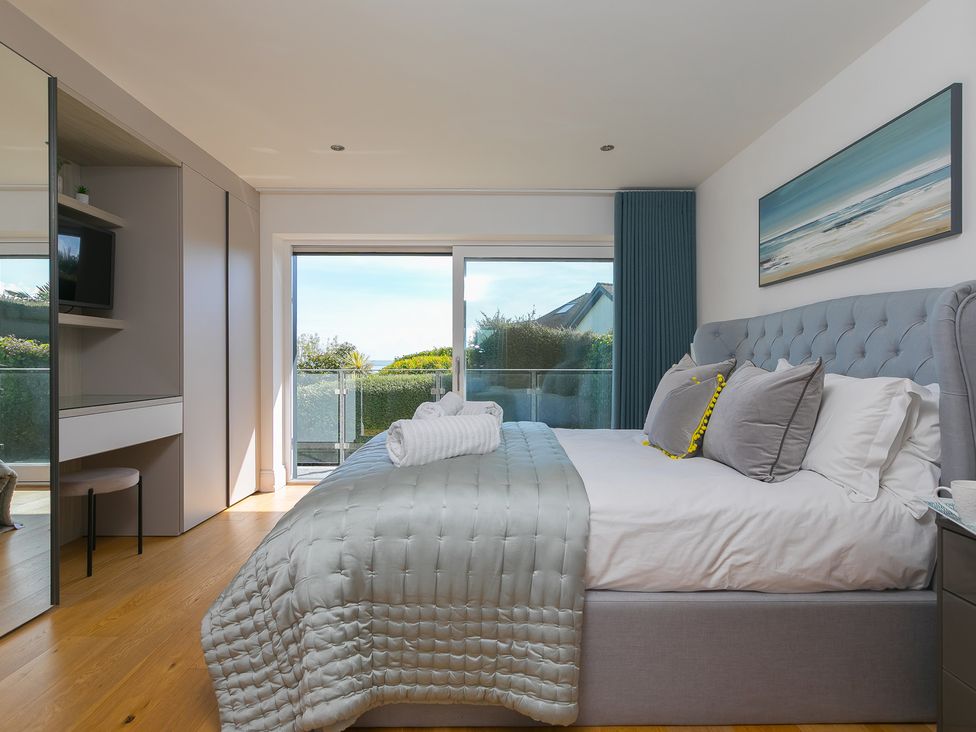 A bedroom with a bed and television at 2 Remera in St Ives