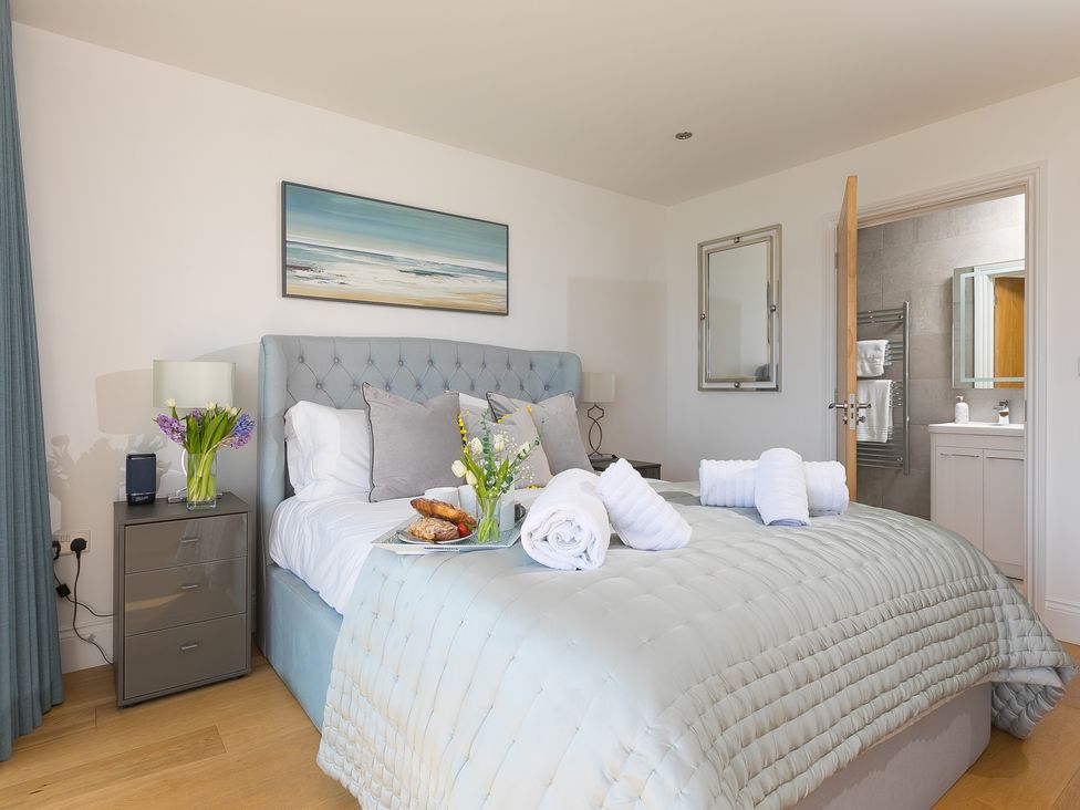 A bedroom with a bed and nightstand at 2 Remera St Ives