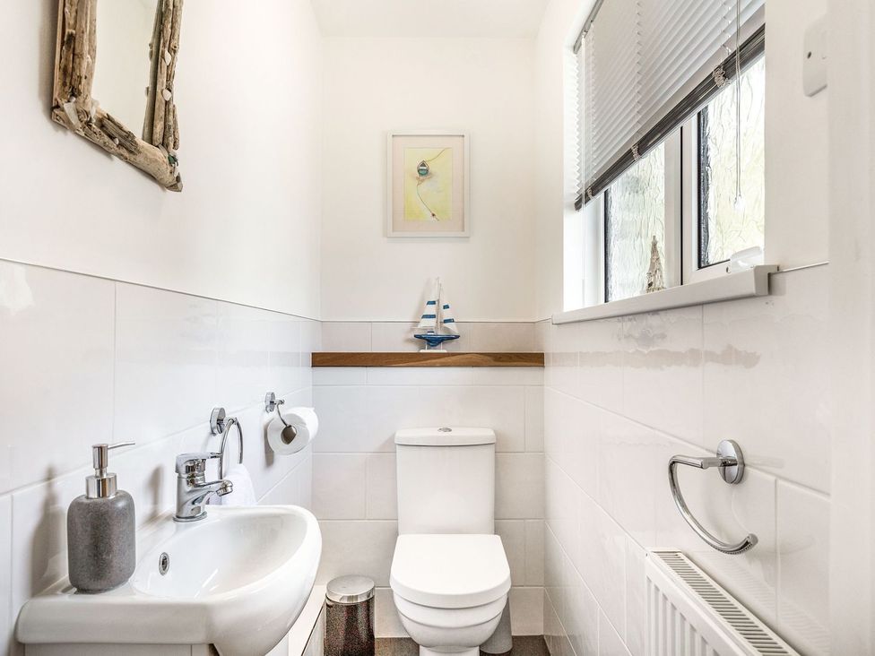 A bathroom with a sink and toilet at Orchard View in St. Austell