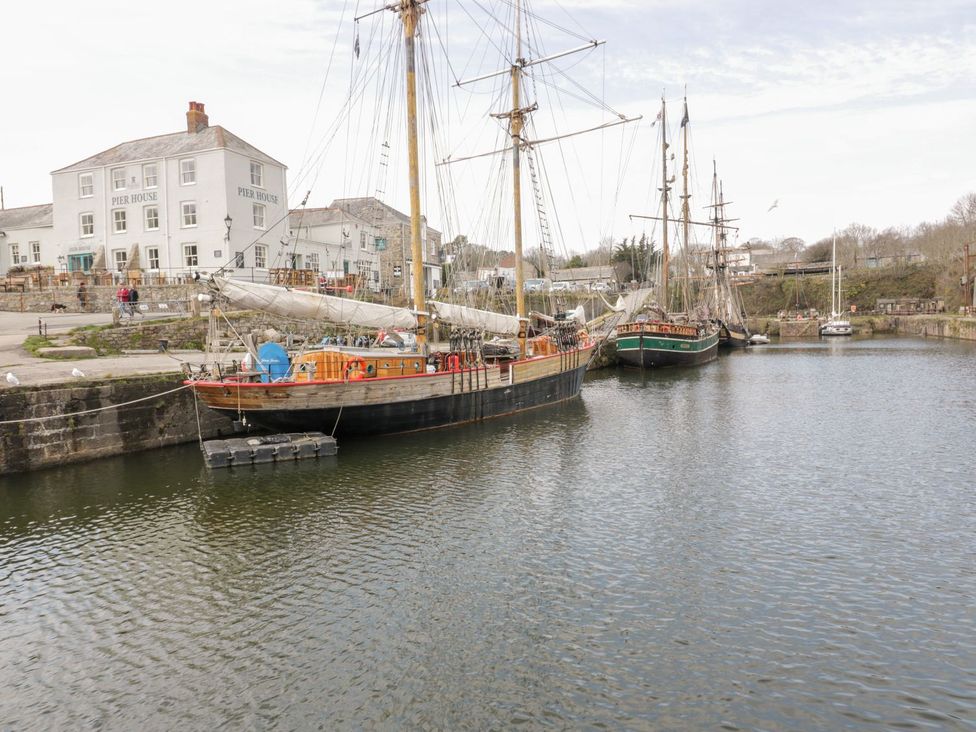 A harbor with sailing ships and buildings at Orchard View in St. Austell