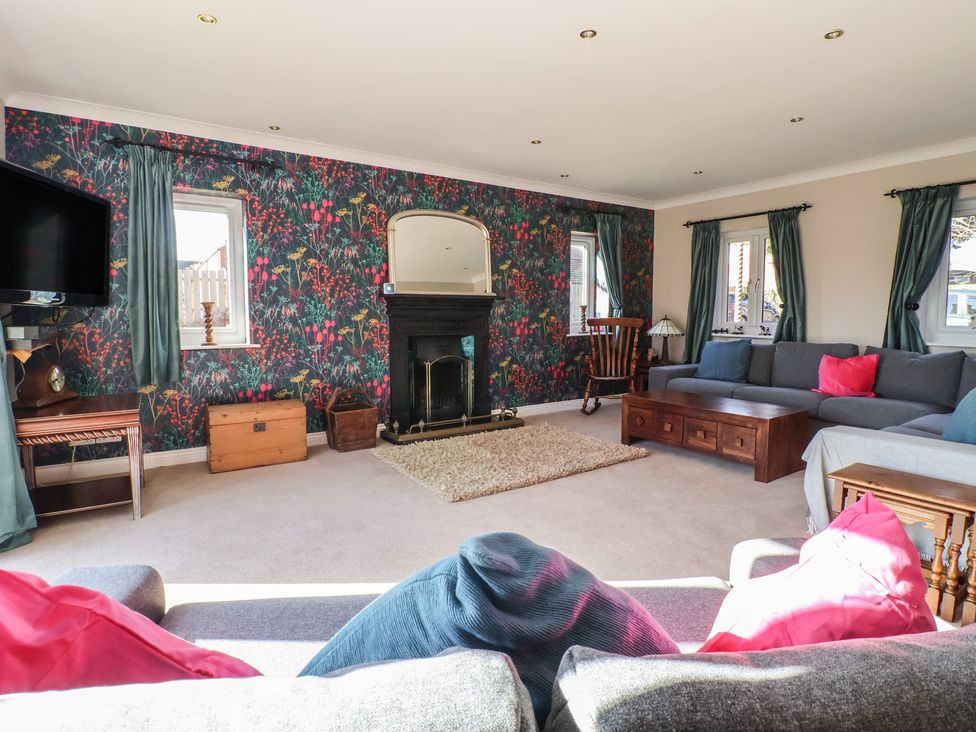 A living room with a fireplace and sofa at The Redwoods