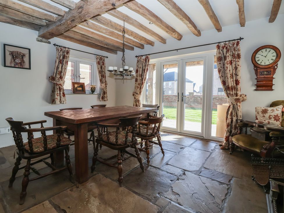 A dining room with a wooden table and chairs at The Redwoods in 