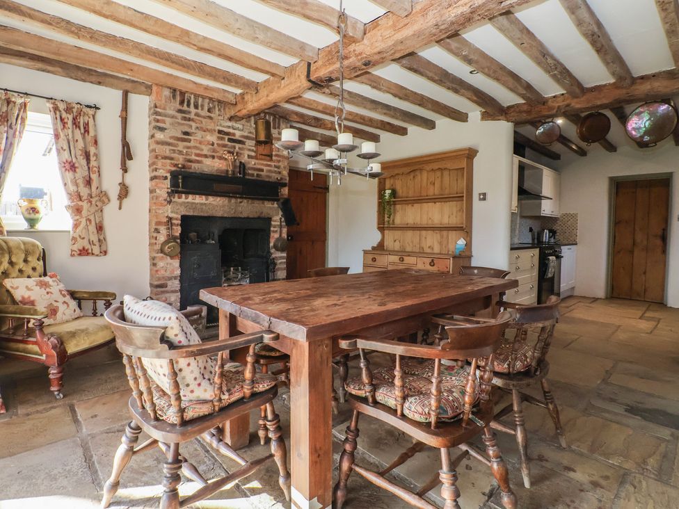 A kitchen with a wooden table and chairs at The Redwoods in 