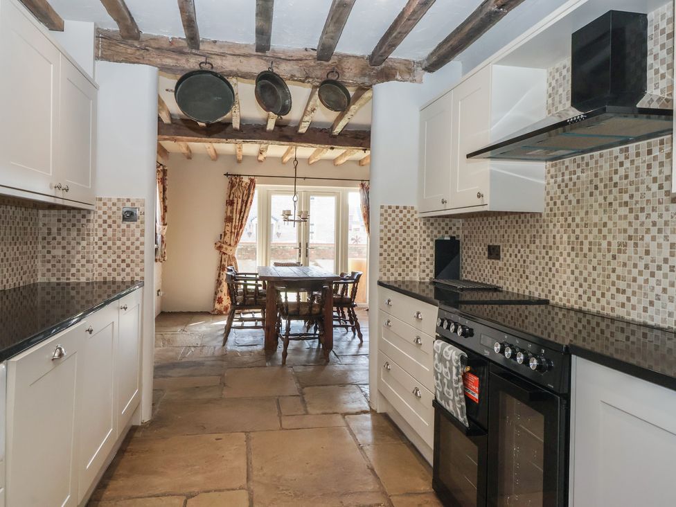 A kitchen with a dining area and cooking appliances at The Redwoods