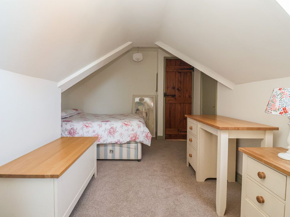 A bedroom with a bed and furniture at The Redwoods in 