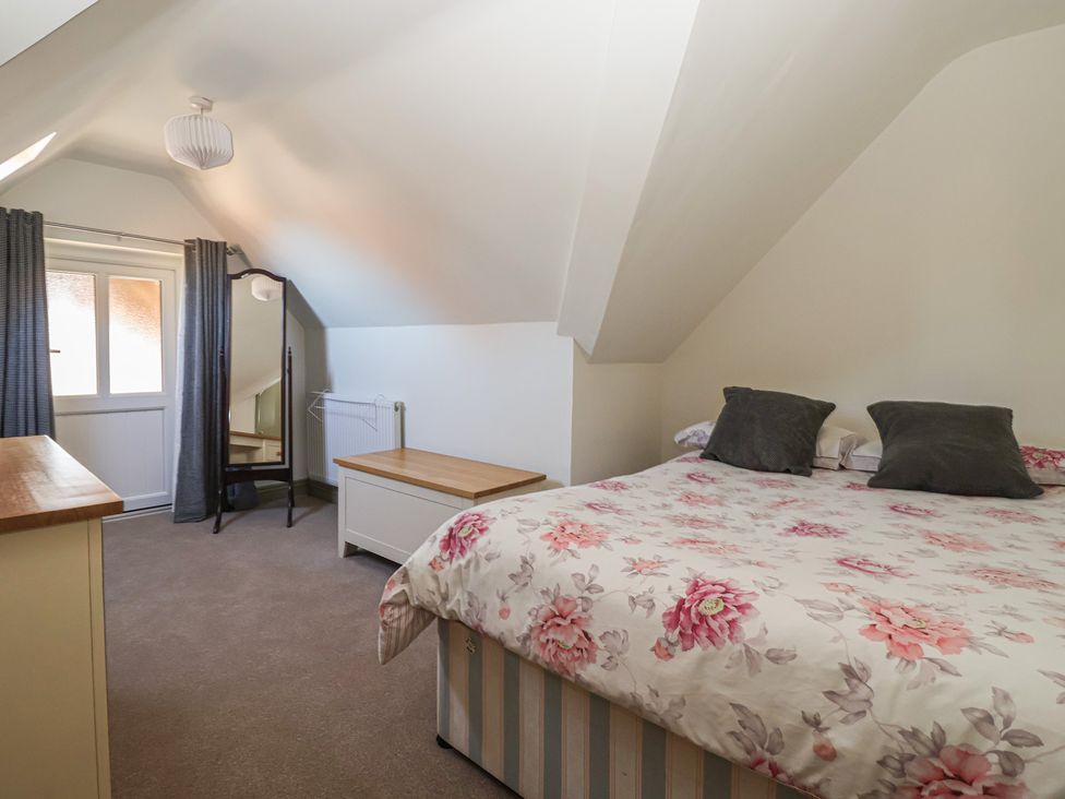 A bedroom with a bed and mirror at The Redwoods 