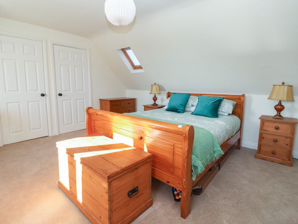 A bedroom with a bed and furniture at The Redwoods