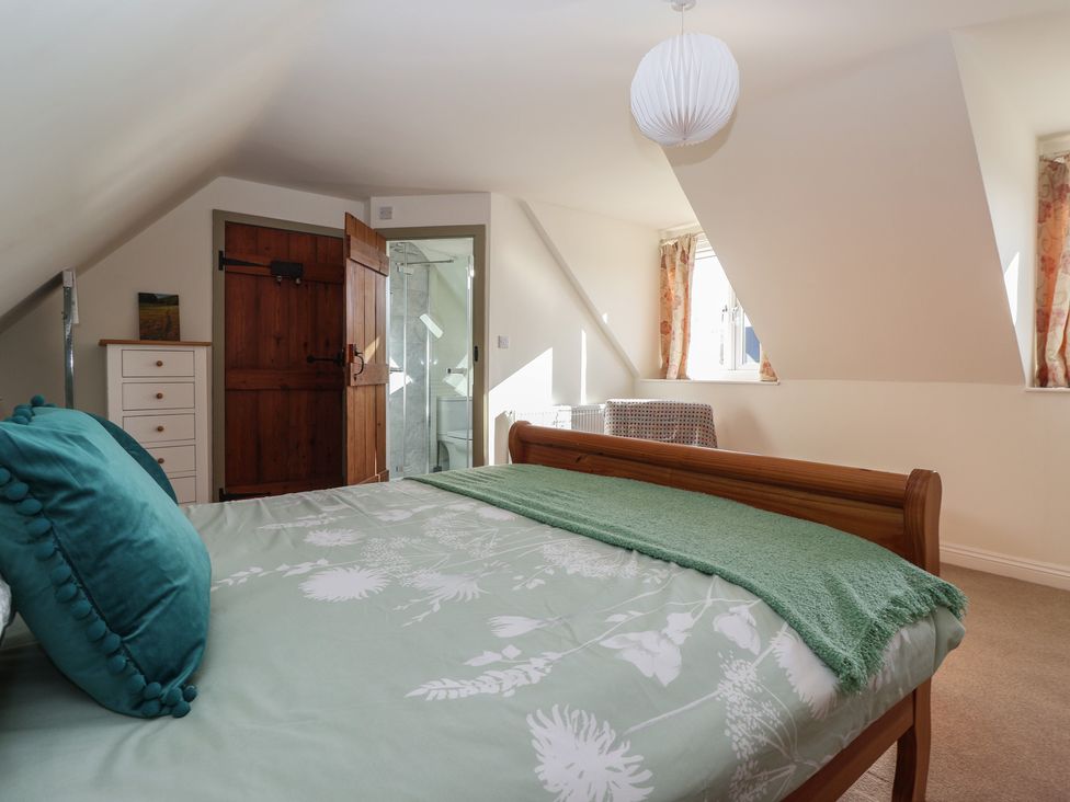 A bedroom with a bed and wardrobe at The Redwoods