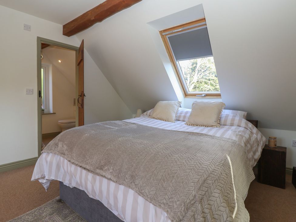 A bedroom with a bed and window at The Redwoods 