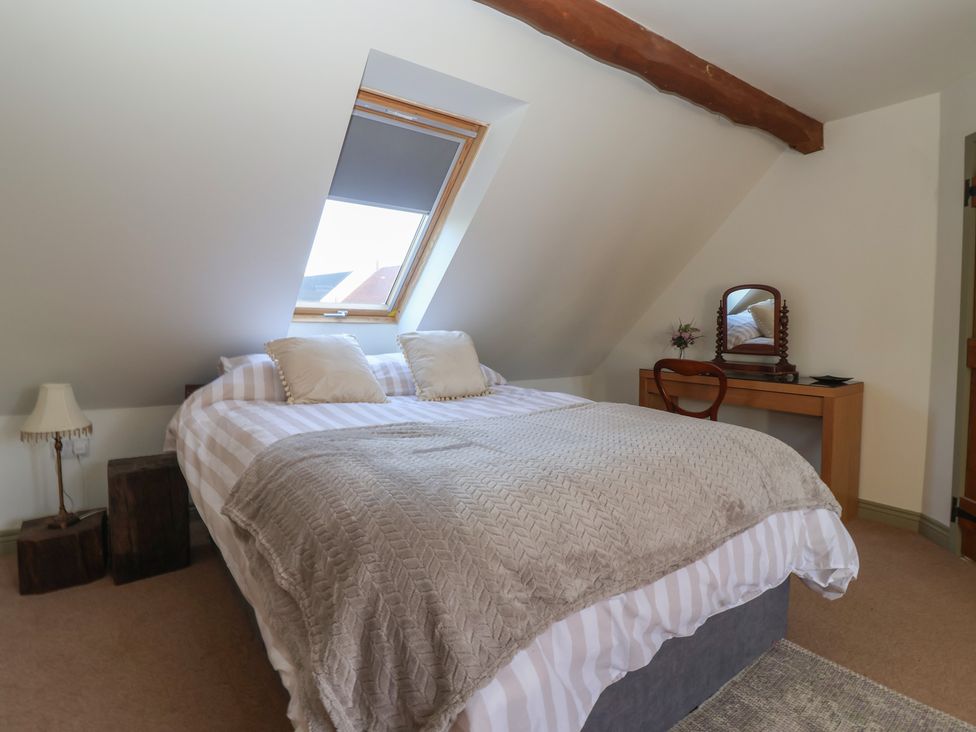 A bedroom with a bed and nightstand at The Redwoods