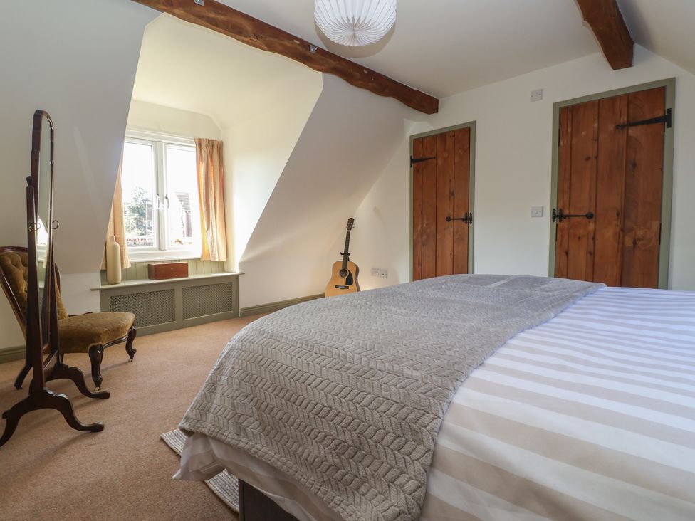 A bedroom with a bed and guitar at The Redwoods 