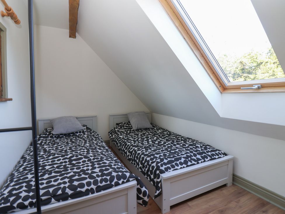 A bedroom with two beds and a window at The Redwoods 