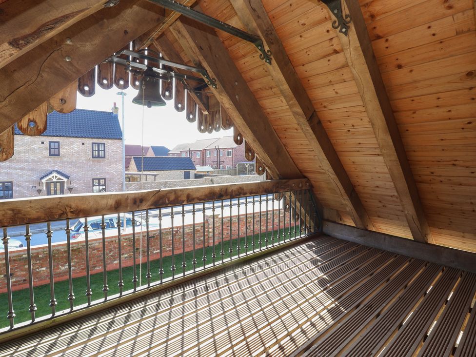 A balcony with wooden beams and a bell at The Redwoods in 
