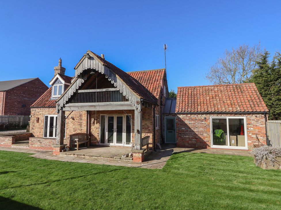 A house with a patio and garden area at Redwoods in Leven Near Beverley