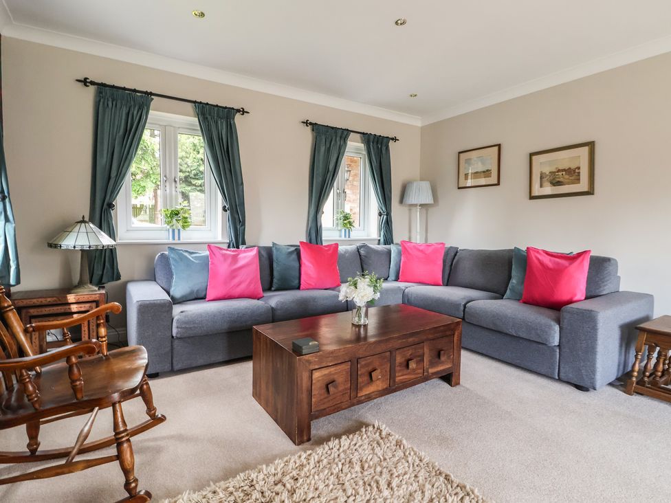 A living room with a sofa and coffee table at Redwoods in Leven Near Beverley
