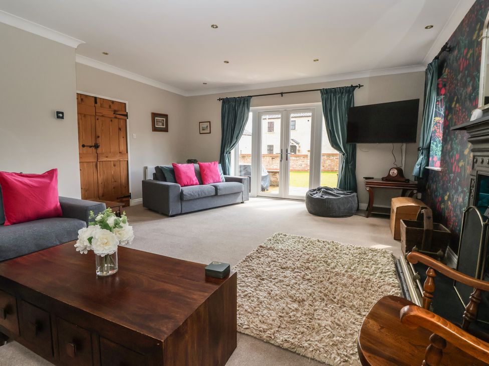 A living room with a coffee table and sofa at Redwoods in Leven Near Beverley