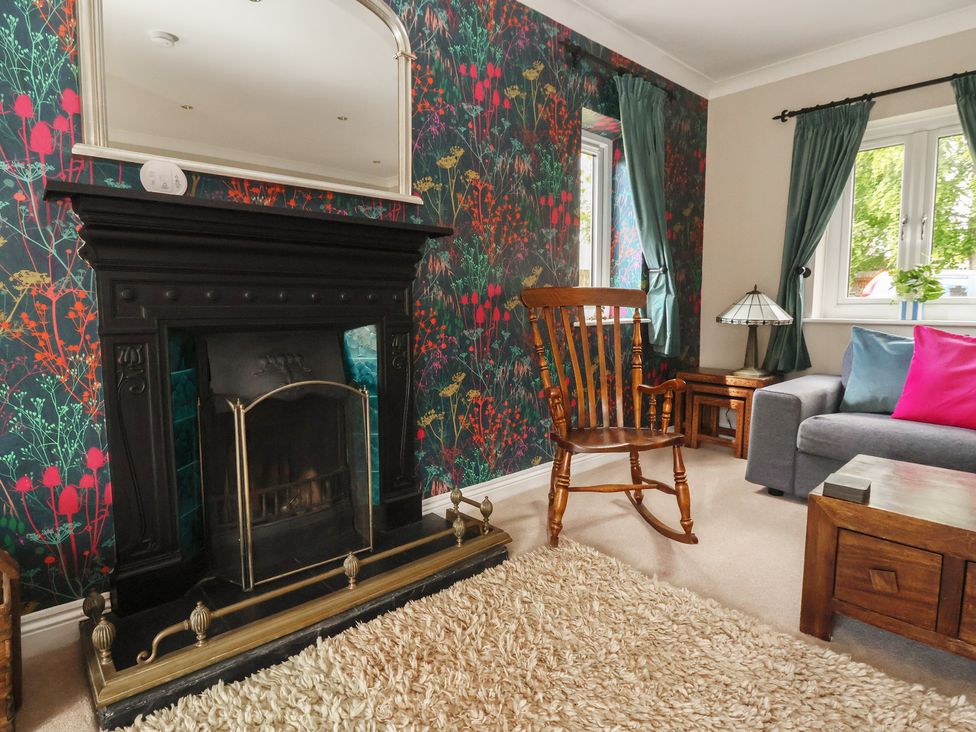 A living room with a fireplace and furniture at Redwoods Leven Near Beverley