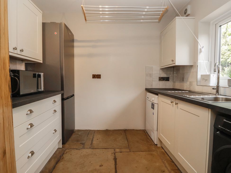A kitchen with appliances and sink at Redwoods in Leven Near Beverley