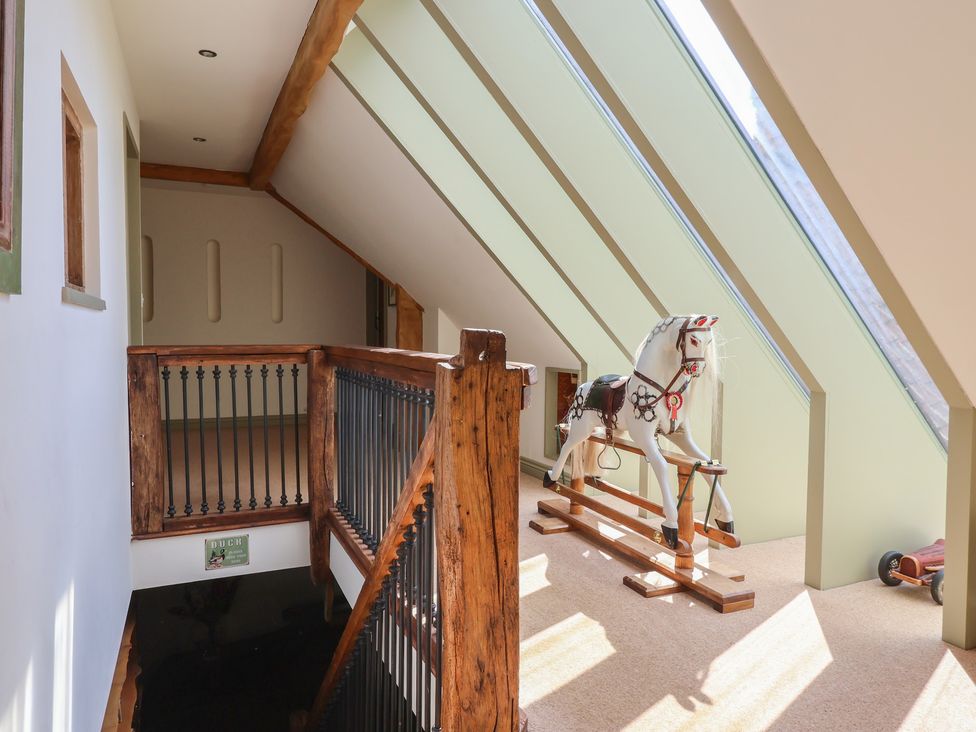A landing with a rocking horse and staircase at Redwoods in Leven Near Beverley