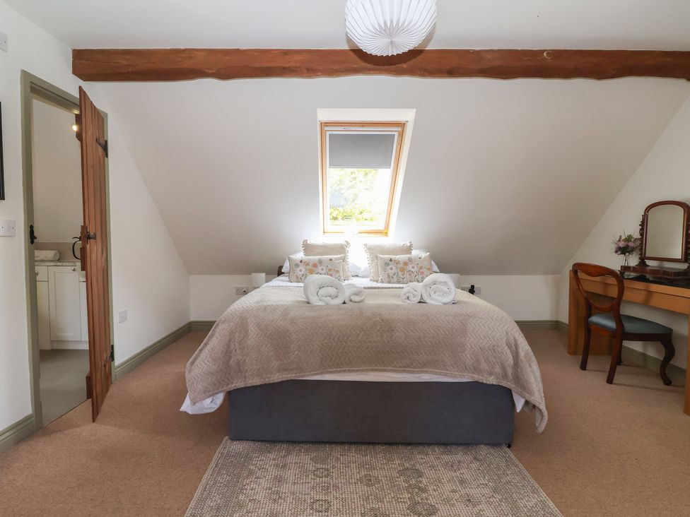 A bedroom with a bed and dresser at Redwoods Leven Near Beverley