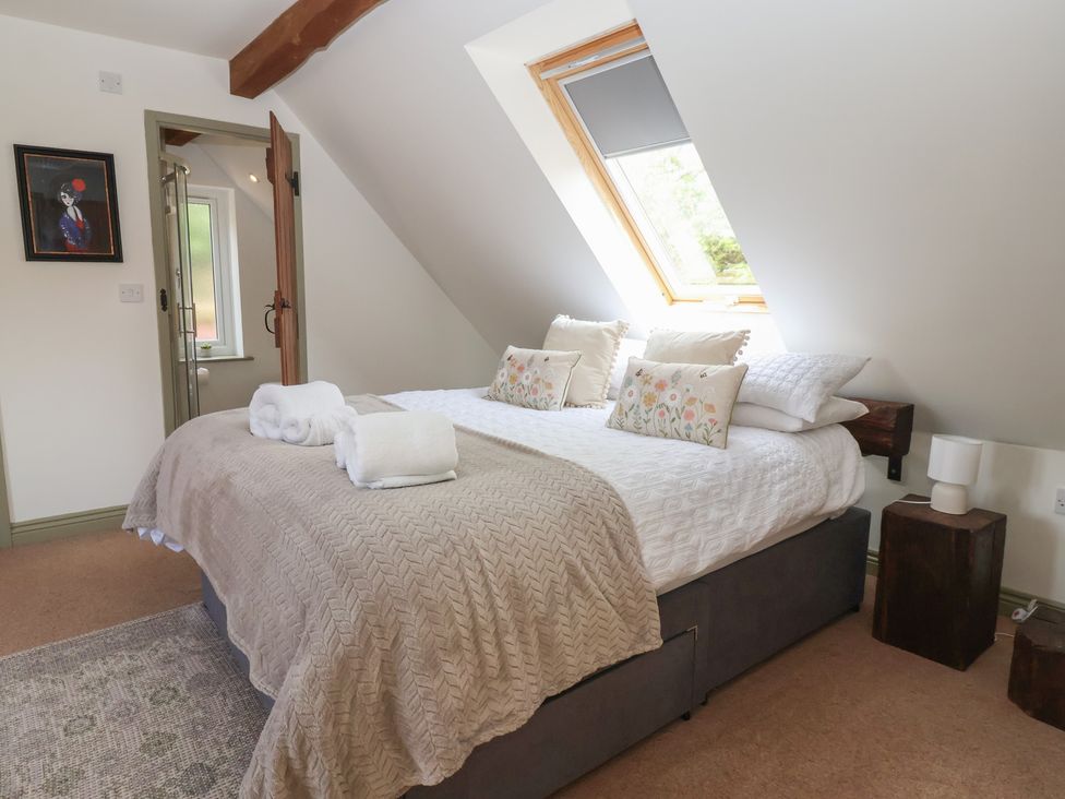 A bedroom with a double bed and pillows at Redwoods Leven Near Beverley