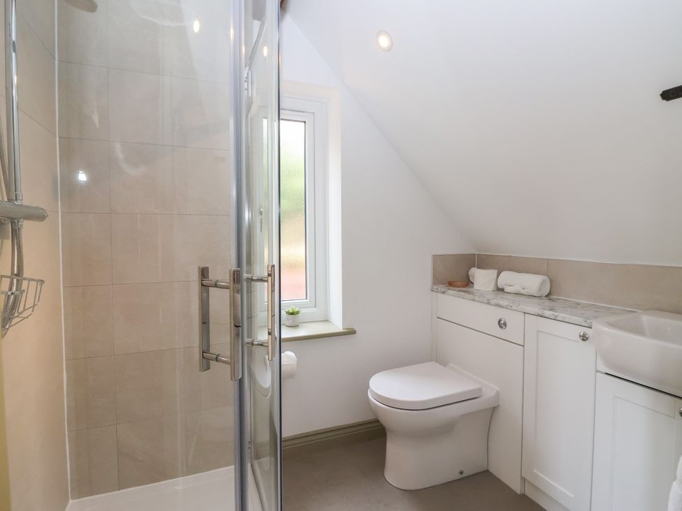 A bathroom with a shower and a toilet at Redwoods in Leven Near Beverley