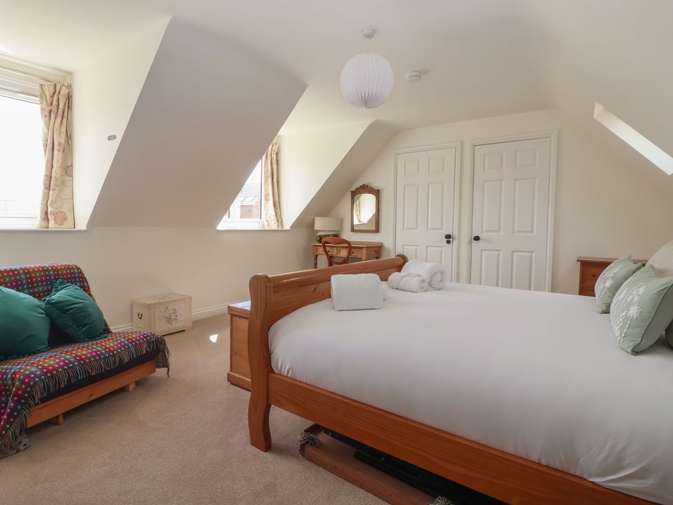A bedroom with a bed and dressing table at Redwoods in Leven Near Beverley
