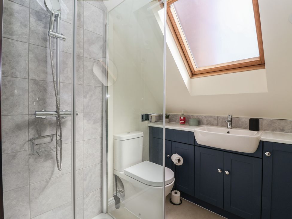 A bathroom with shower, toilet and sink at Redwoods in Leven Near Beverley