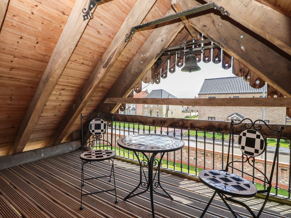 A balcony with a table and chairs at Redwoods Leven Near Beverley