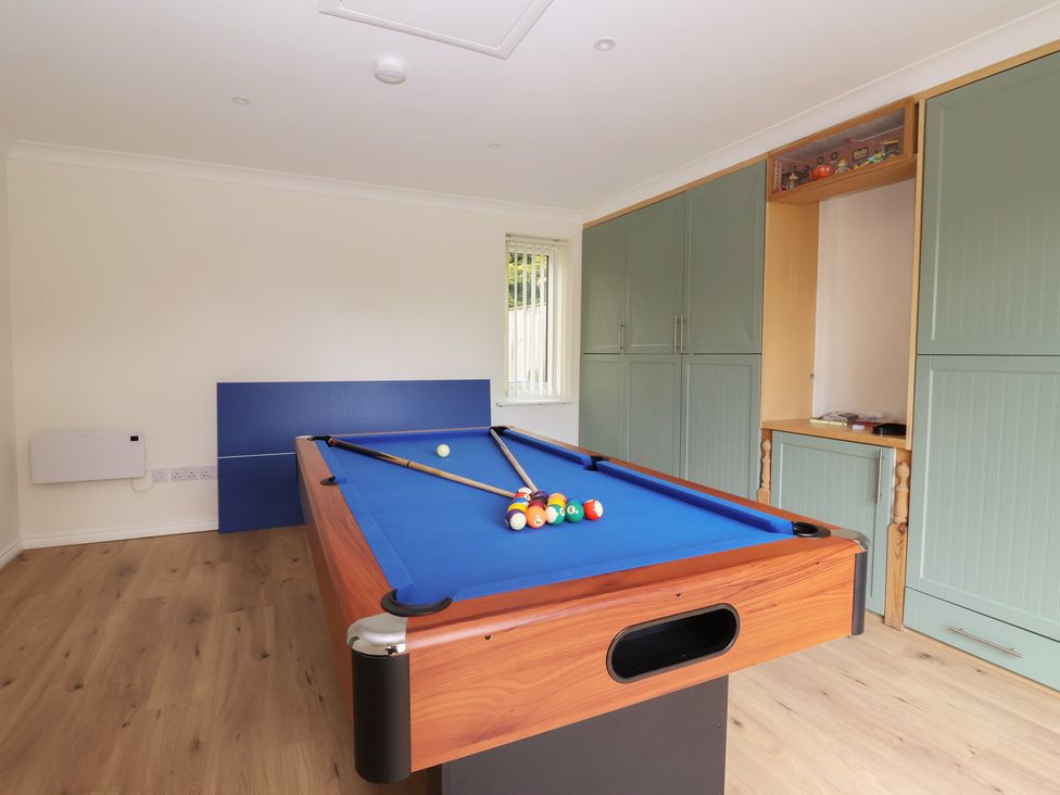 A games room with a pool table and storage cabinets at Redwoods in Leven Near Beverley