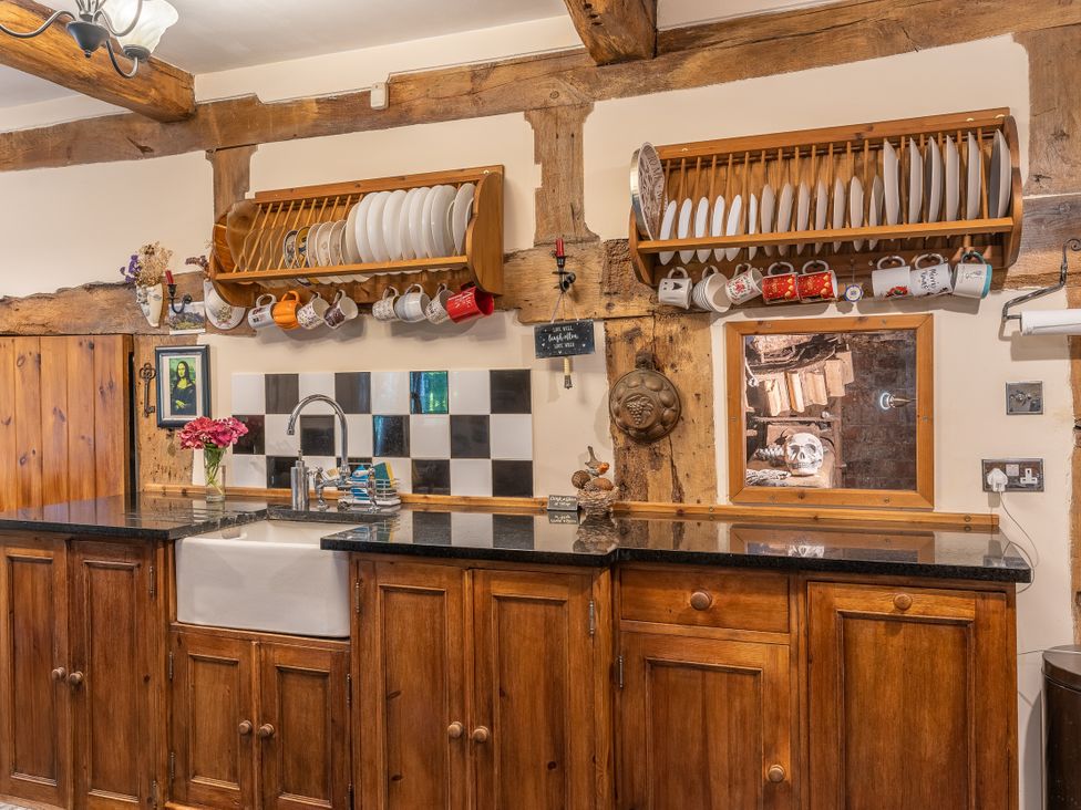 A kitchen with cabinets and a sink at Hadley Park Windmill