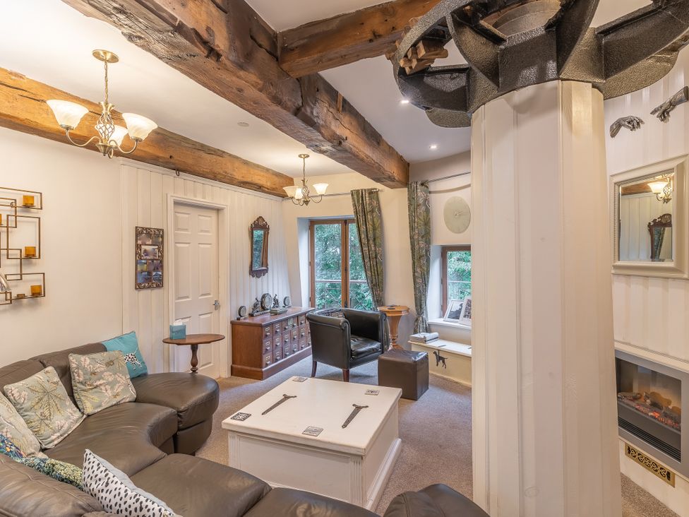 A living room with a sofa and coffee table at Hadley Park Windmill
