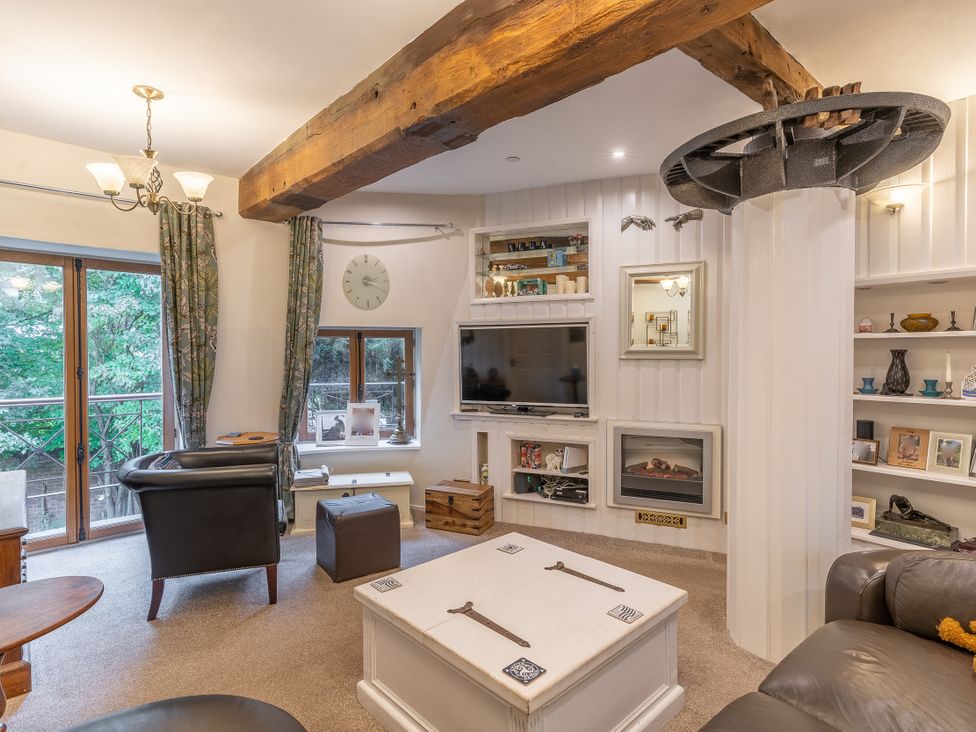 A living room with a sofa and coffee table at Hadley Park Windmill