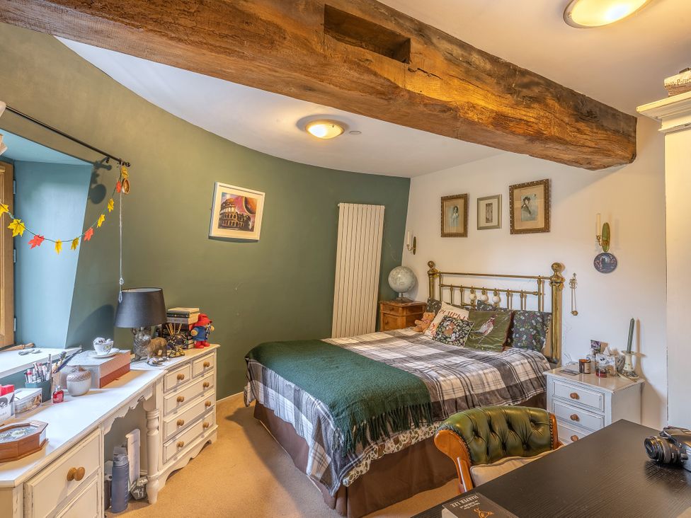 A bedroom with a bed and desk at Hadley Park Windmill