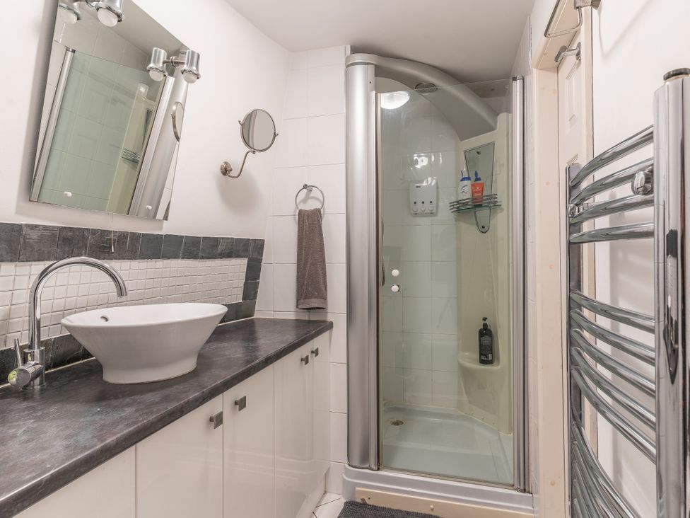 A bathroom featuring a sink, shower, and mirror at Hadley Park Windmill