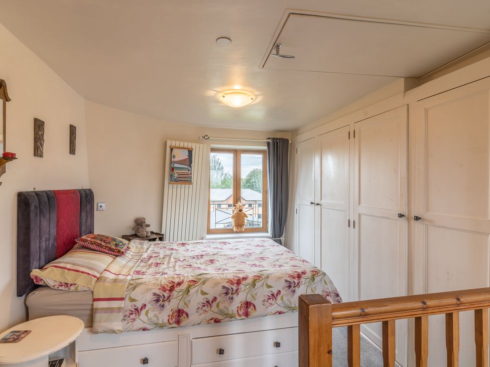 A bedroom with a bed and wardrobe at Hadley Park Windmill
