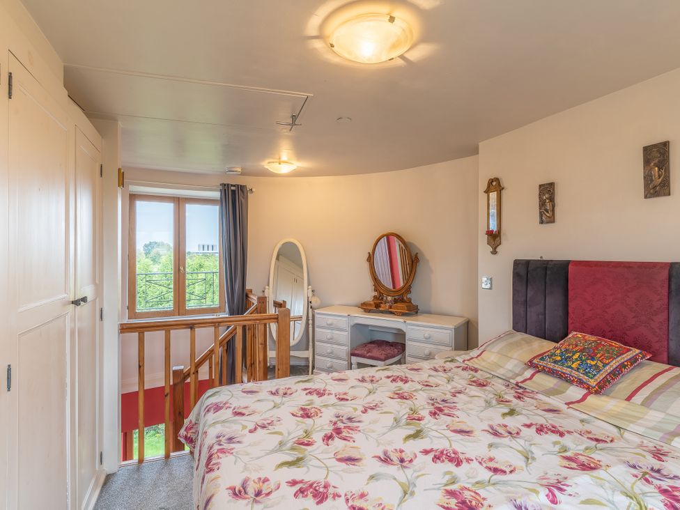 A bedroom with a bed and mirror at Hadley Park Windmill in 