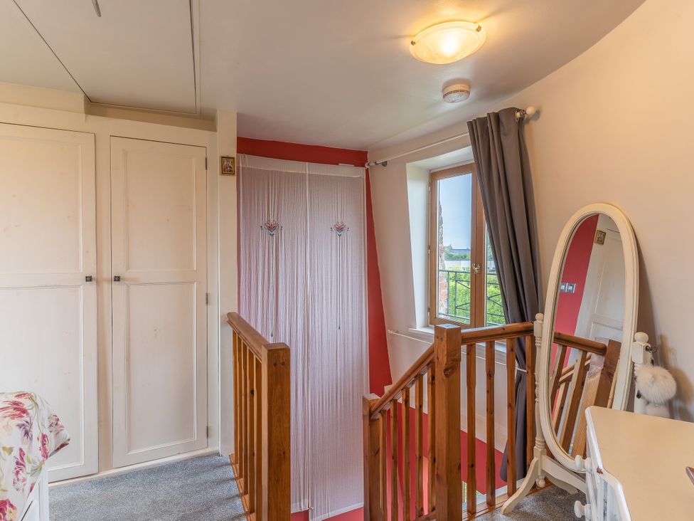 A landing area with mirror and window at Hadley Park Windmill 