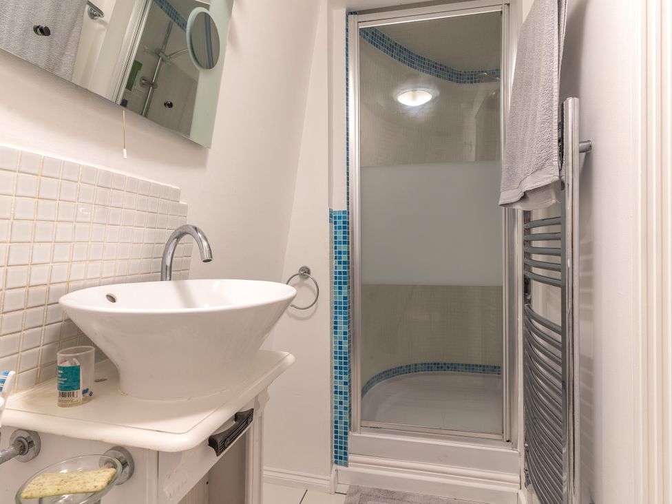 A bathroom featuring a sink, shower, and mirror at Hadley Park Windmill