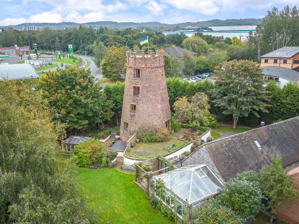 A garden with a tower and glasshouse at Hadley Park Windmill