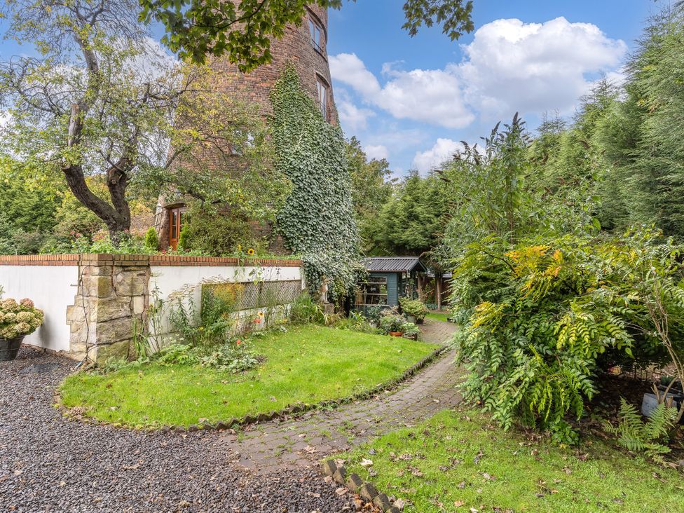 A garden with a pathway and trees at Hadley Park Windmill, 