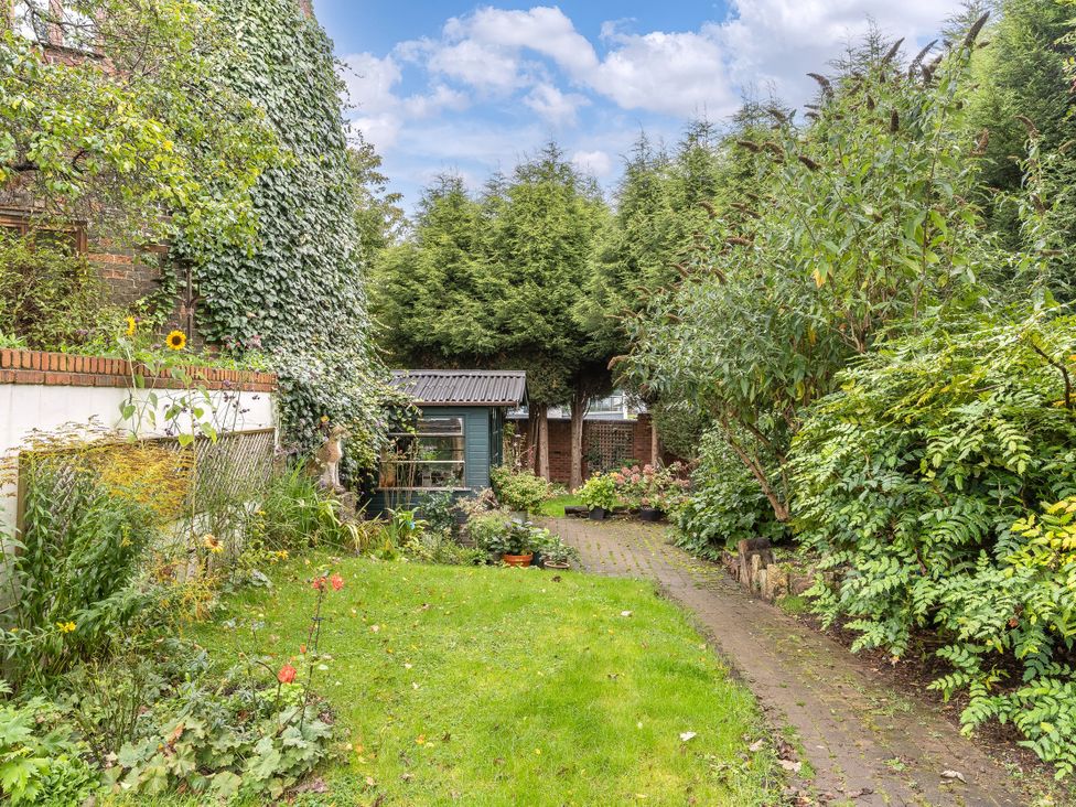 A garden with a pathway and a shed at Hadley Park Windmill