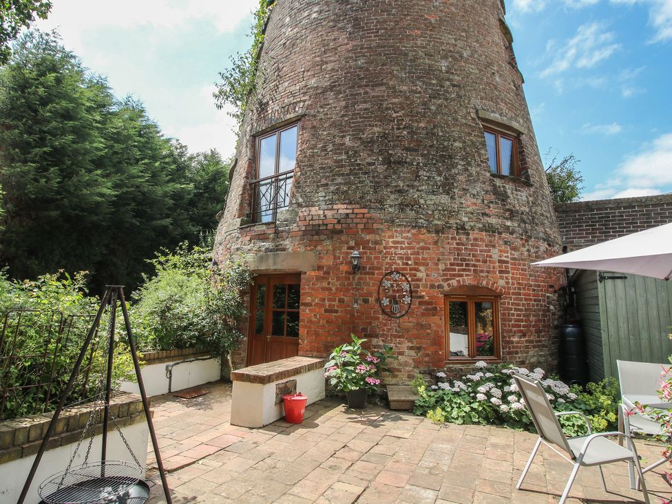 An outdoor area with a brick structure and plants at Hadley Park Windmill near Telford