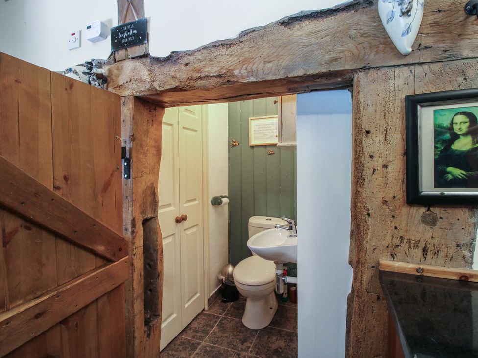 A bathroom with a toilet and sink at Hadley Park Windmill near Telford