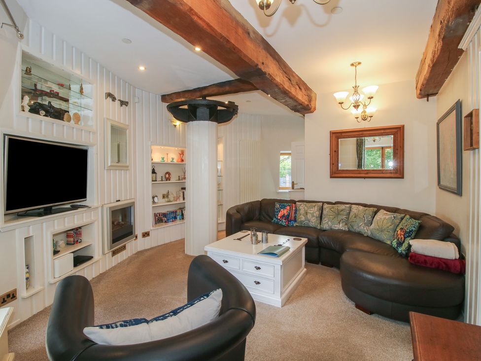A living room with a sofa and television at Hadley Park Windmill near Telford