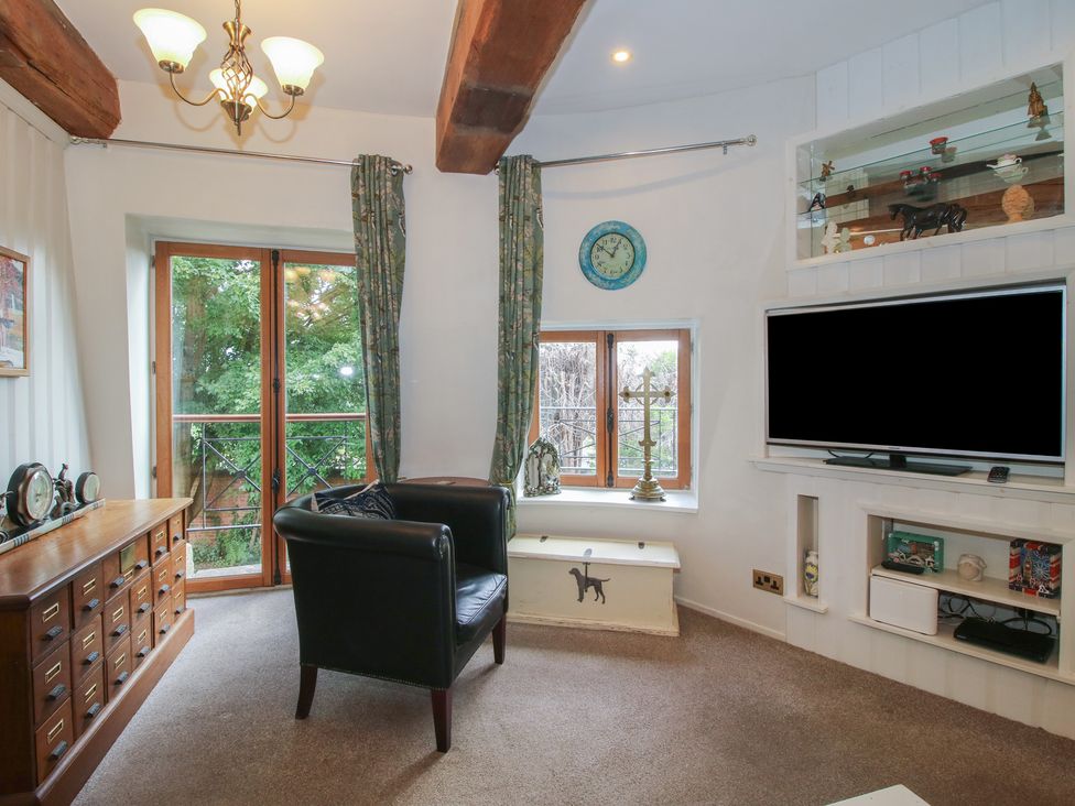 A living room with a sofa and television at Hadley Park Windmill near Telford