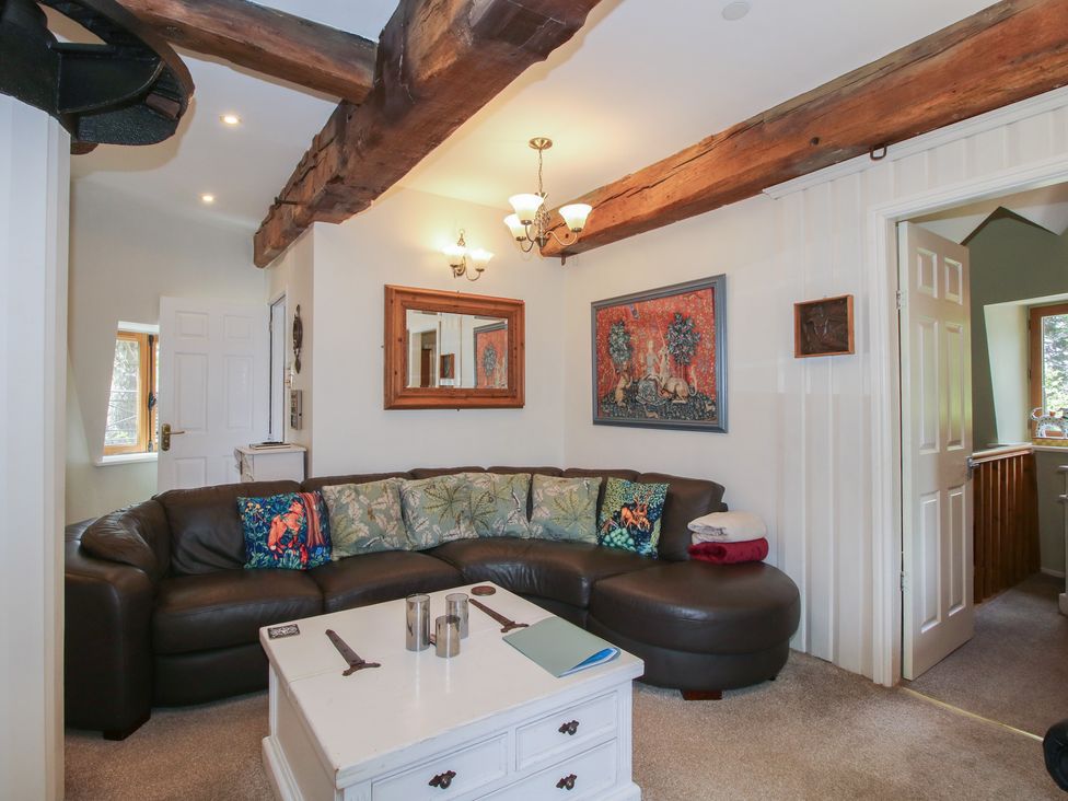 A living room with a sofa and coffee table at Hadley Park Windmill near Telford