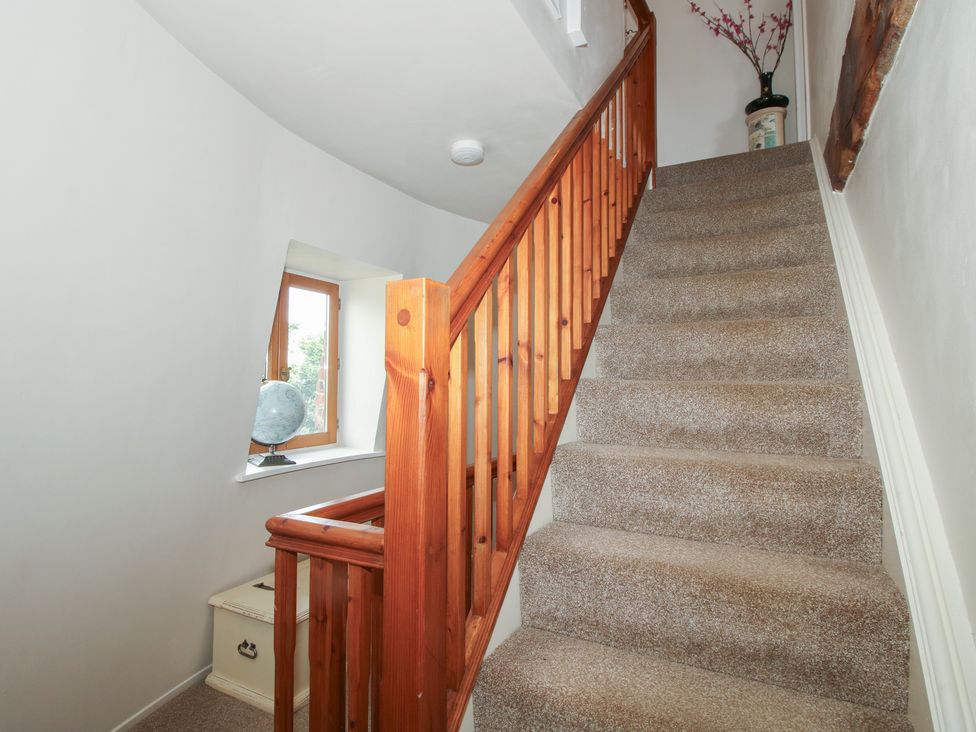 Stairs with wooden handrail and globe in a staircase at Hadley Park Windmill near Telford