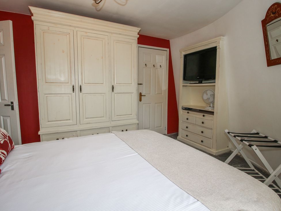 A bedroom with a wardrobe and TV at Hadley Park Windmill near Telford